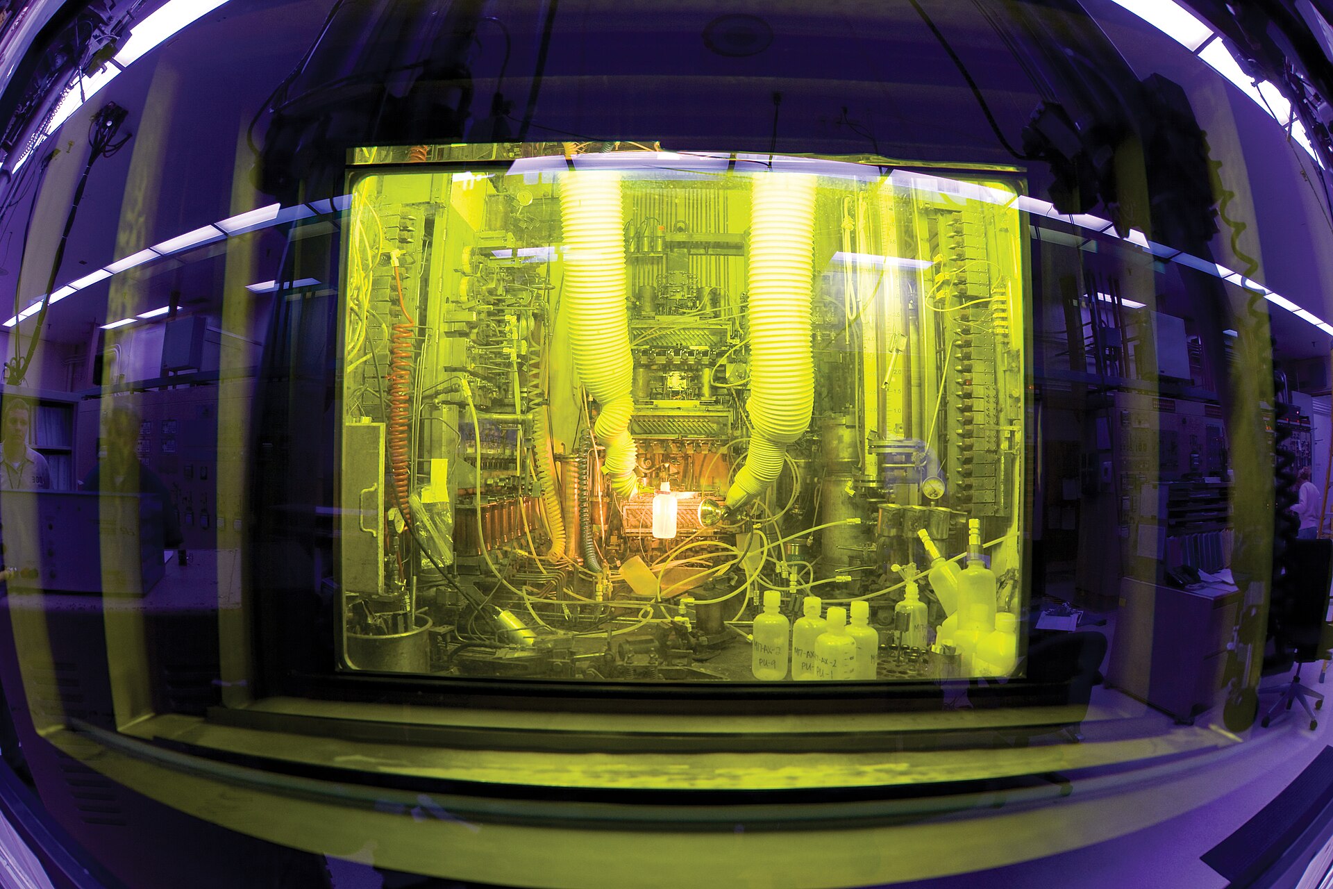 Equipment inside an Oak Ridge hot cell, viewed through its shielded window.